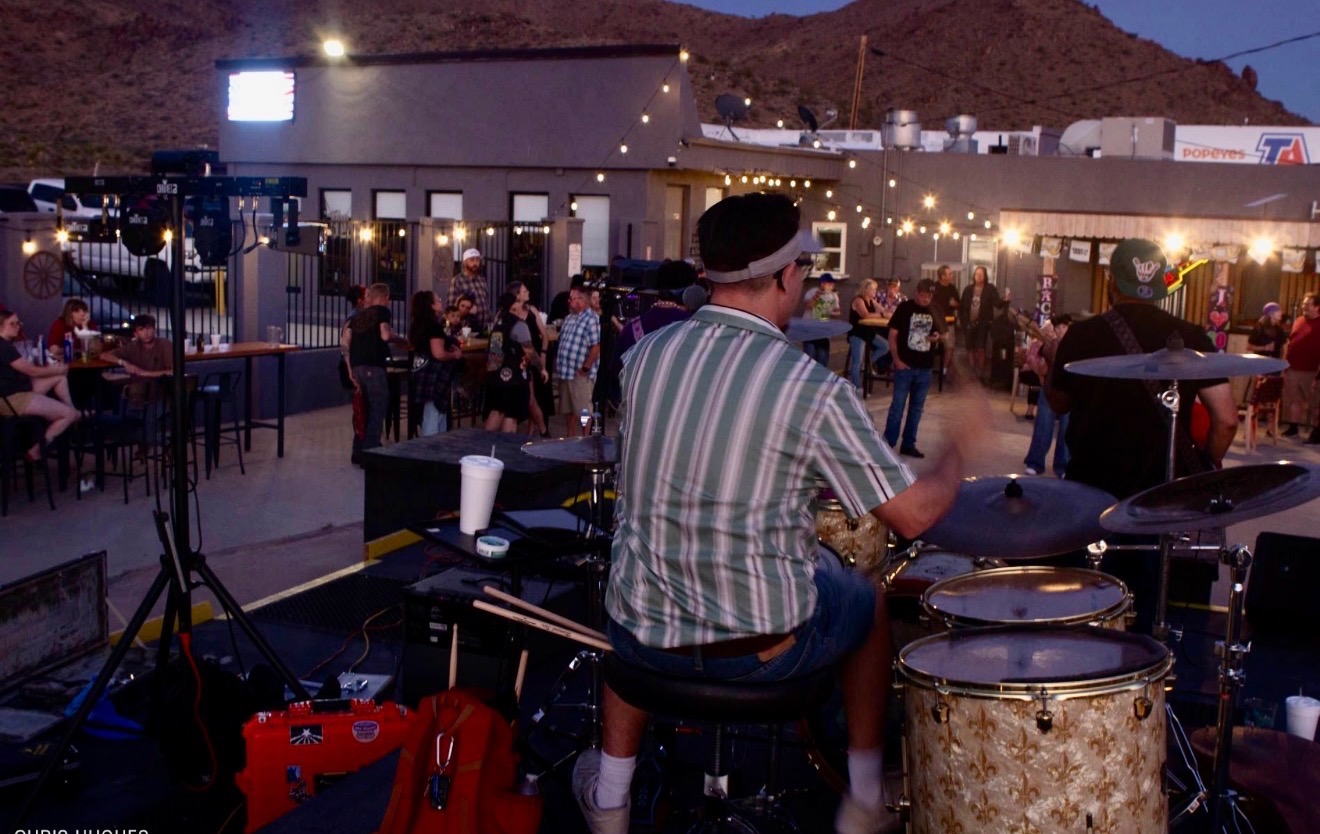 Packed patio at Castle Rock during a live music night at dusk
