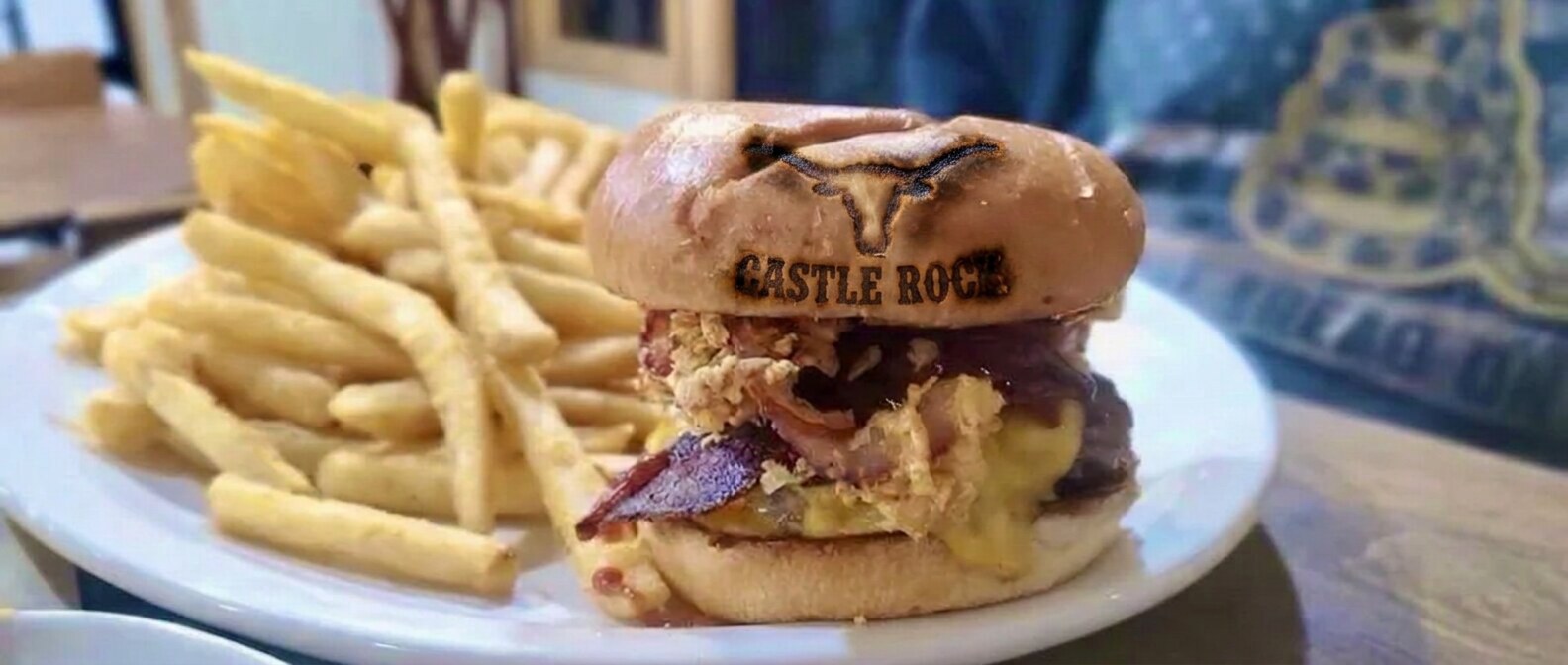 Cheddar bacon BBQ burger with fried onions and fries at Castle Rock